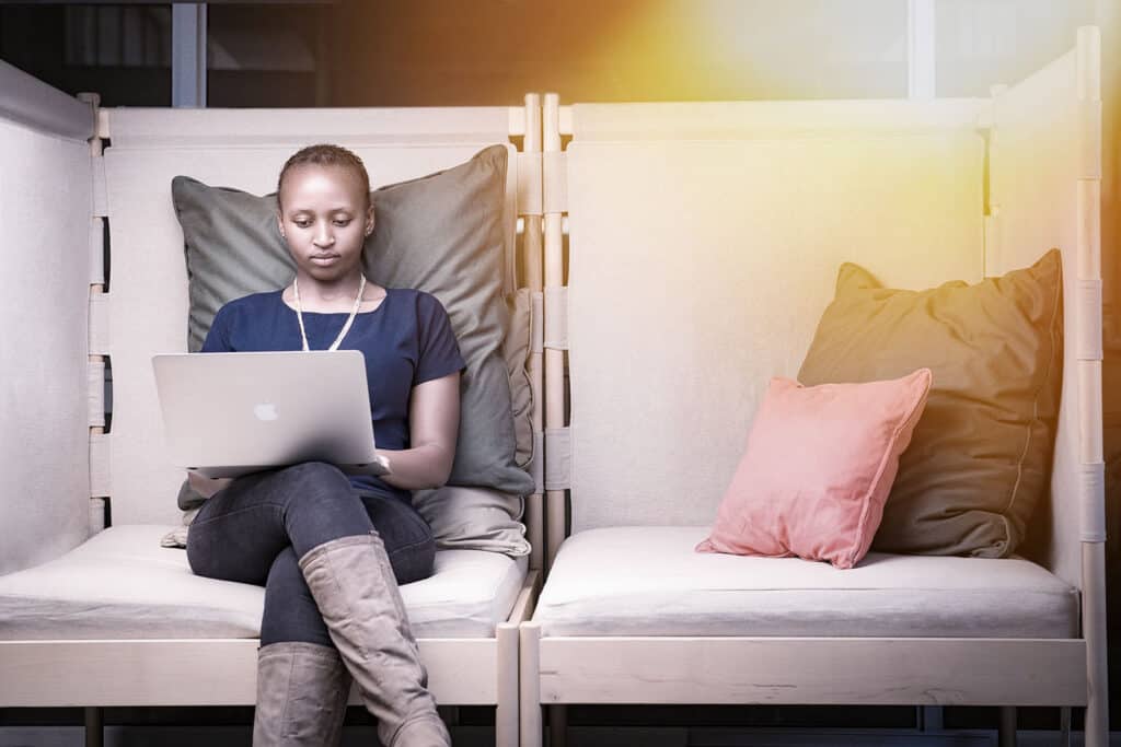 African lady seating at a coworking space at Nairobi Garage